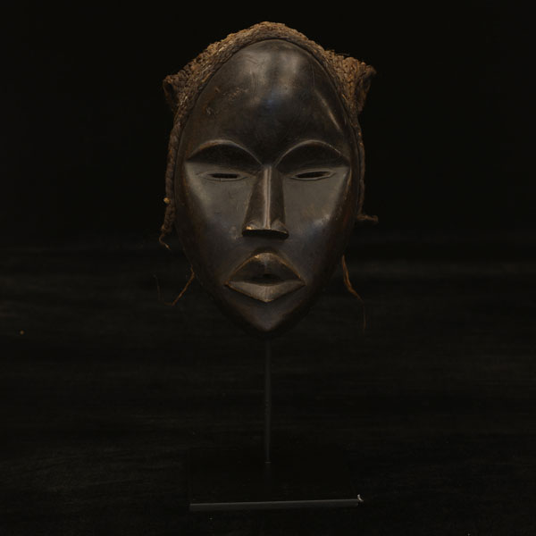 African mask on display stand