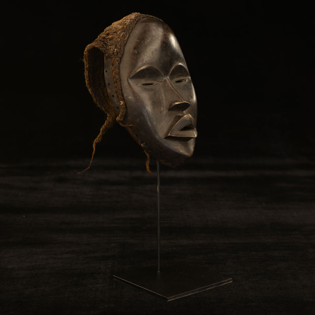 African mask on display stand