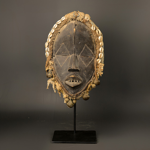 African Dan mask on display stand
